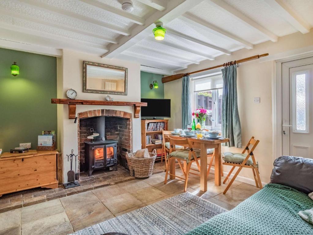 a living room with a table and a fireplace at 2 Bed in Bacton 86430 in Bacton