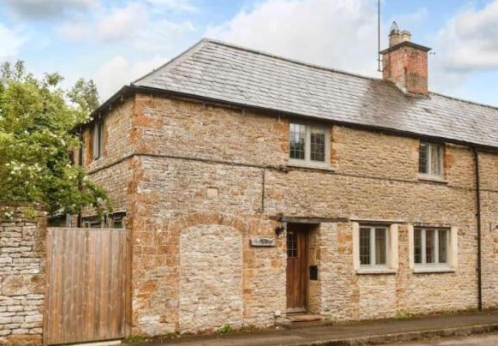 an old brick house with a wooden gate at 18th Cent Cottage - 5min drive Soho Farmhouse in Ledwell