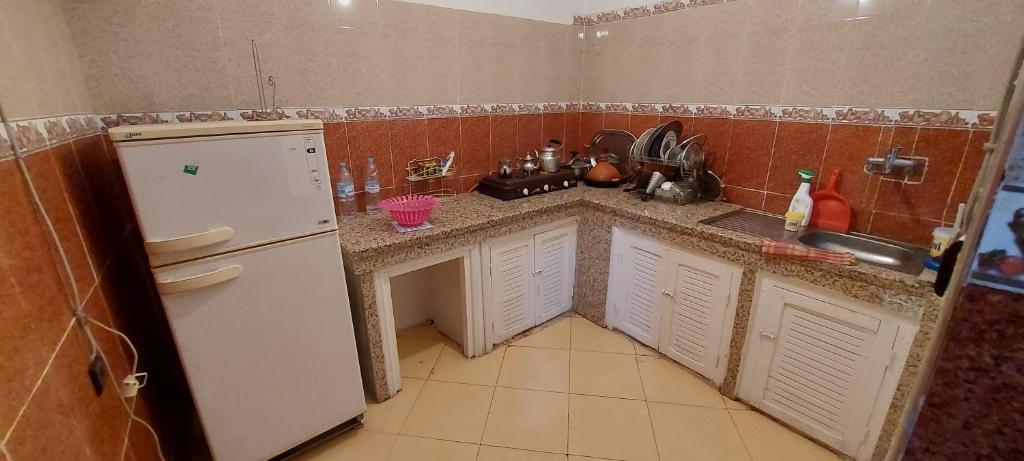 a small kitchen with a sink and a refrigerator at Cozy Appartement in Midelt in Midelt