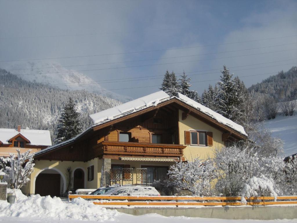 a house with snow on the roof at Haus Kogler in Aich