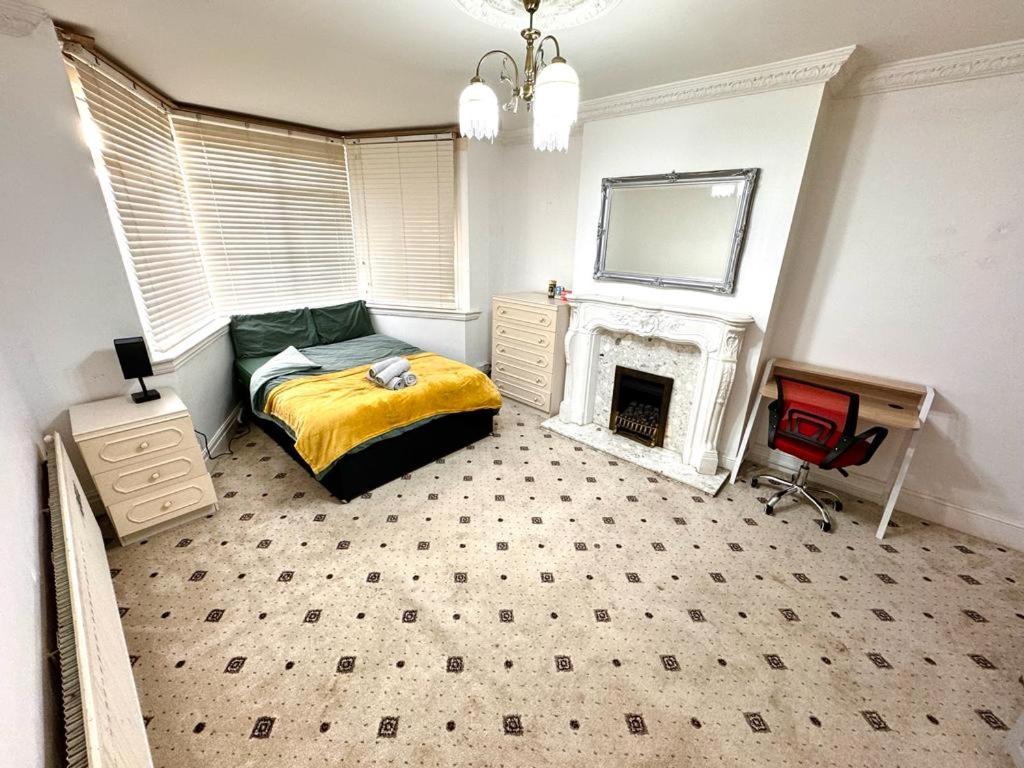 a bedroom with a bed and a fireplace at Topaz XL Room 1 near QE & UOB in Birmingham