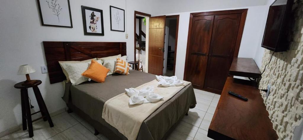 um quarto com uma cama com duas toalhas em Pousada na Praia Maricá em Maricá