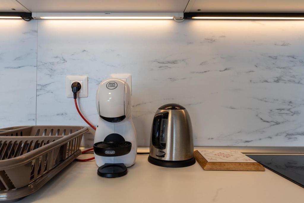 a kitchen counter with a coffee maker and a toaster at Bliss - Studio au pied des pistes in Villarembert