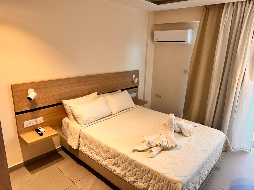 Postel nebo postele na pokoji v ubytování San Remo Hotel