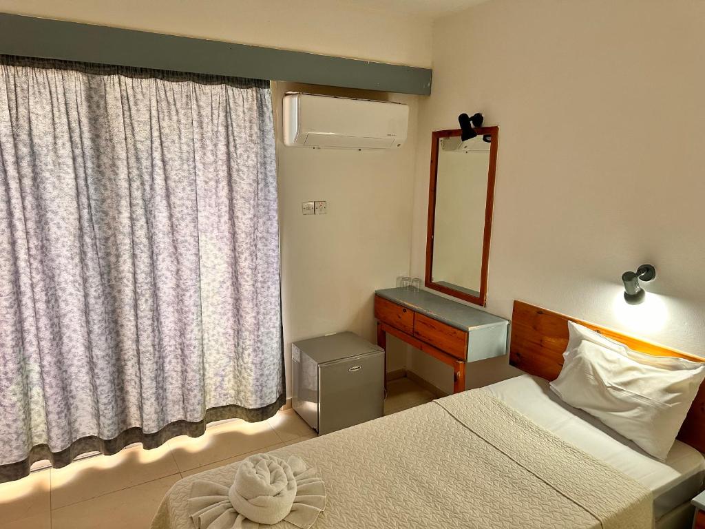 Postel nebo postele na pokoji v ubytování San Remo Hotel