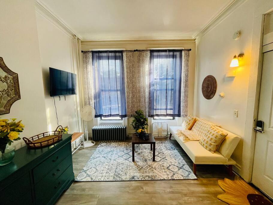 a living room with a couch and a table at Cozy 1BR with Patio in the Heart of Albany in Albany