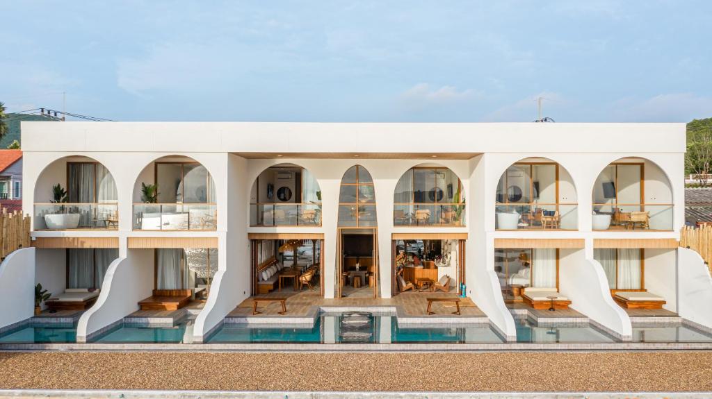 an external view of a building with a pool at Tasana bar and luxury resort in Ko Larn