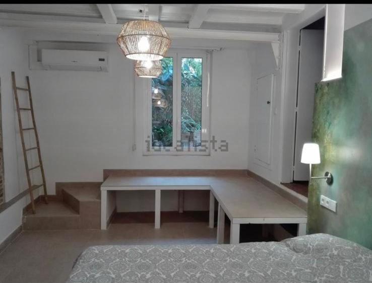 a living room with a table and a window at LINDA HABITACION PRIVADA in Barcelona