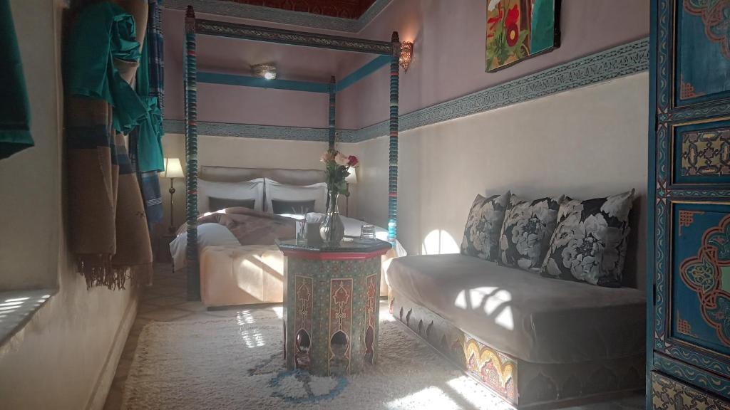 a living room with a couch and a bed at Riad Maizie in Marrakesh