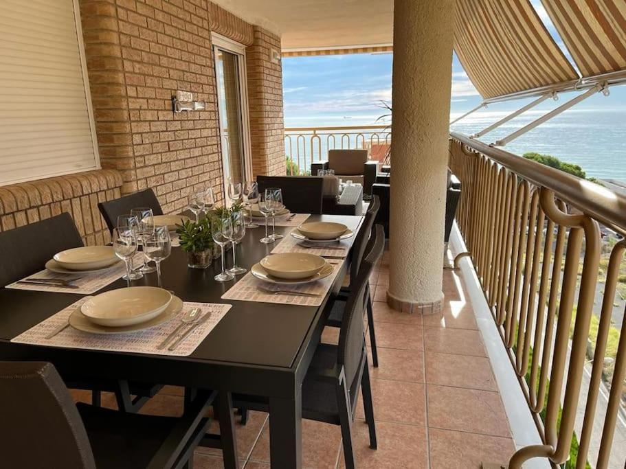 a dining room with a table and a balcony at Apartamento en Benicassim. in Benicàssim