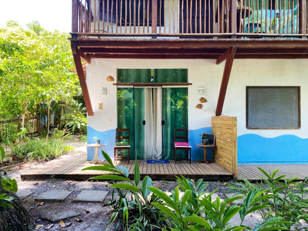 uma casa com uma porta verde e uma varanda em Barra Quintal - Studio 1 em Barra Grande