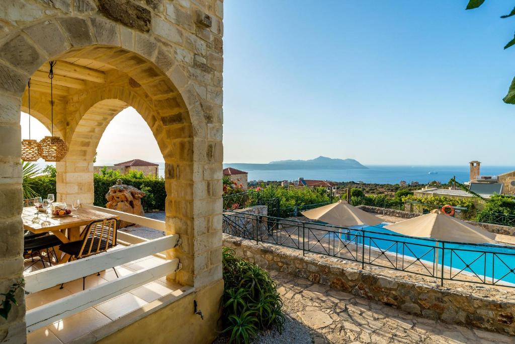 a view from the house of the patio and swimming pool at Villa Thalia St George Retreat BY APOKORONAS-VILLAS in Kókkinon Khoríon