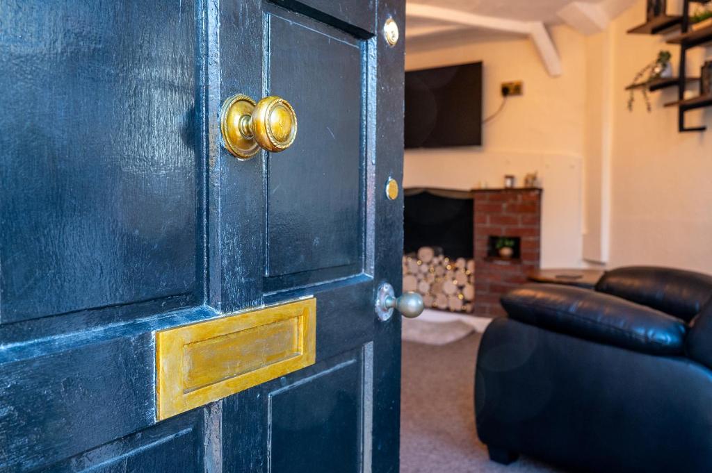 a blue door in a living room with a couch at Town Centre Cottage 3 Bedroom inc Parking (1 car) in Shrewsbury