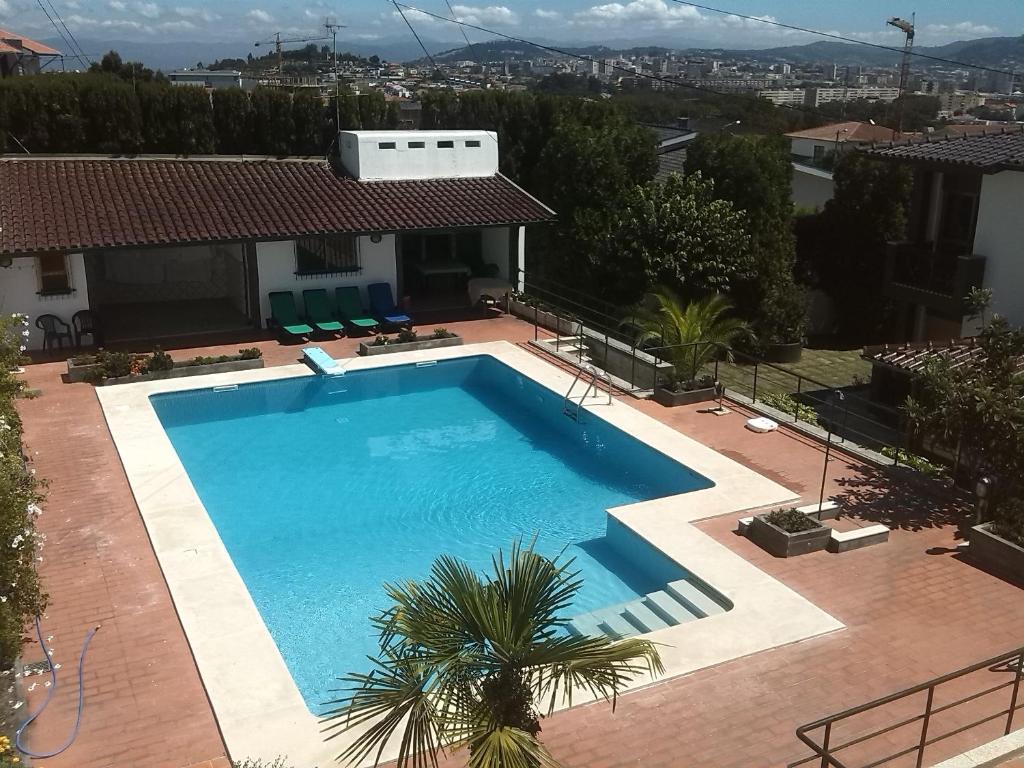a swimming pool on top of a house at Gardenia Residence in Braga