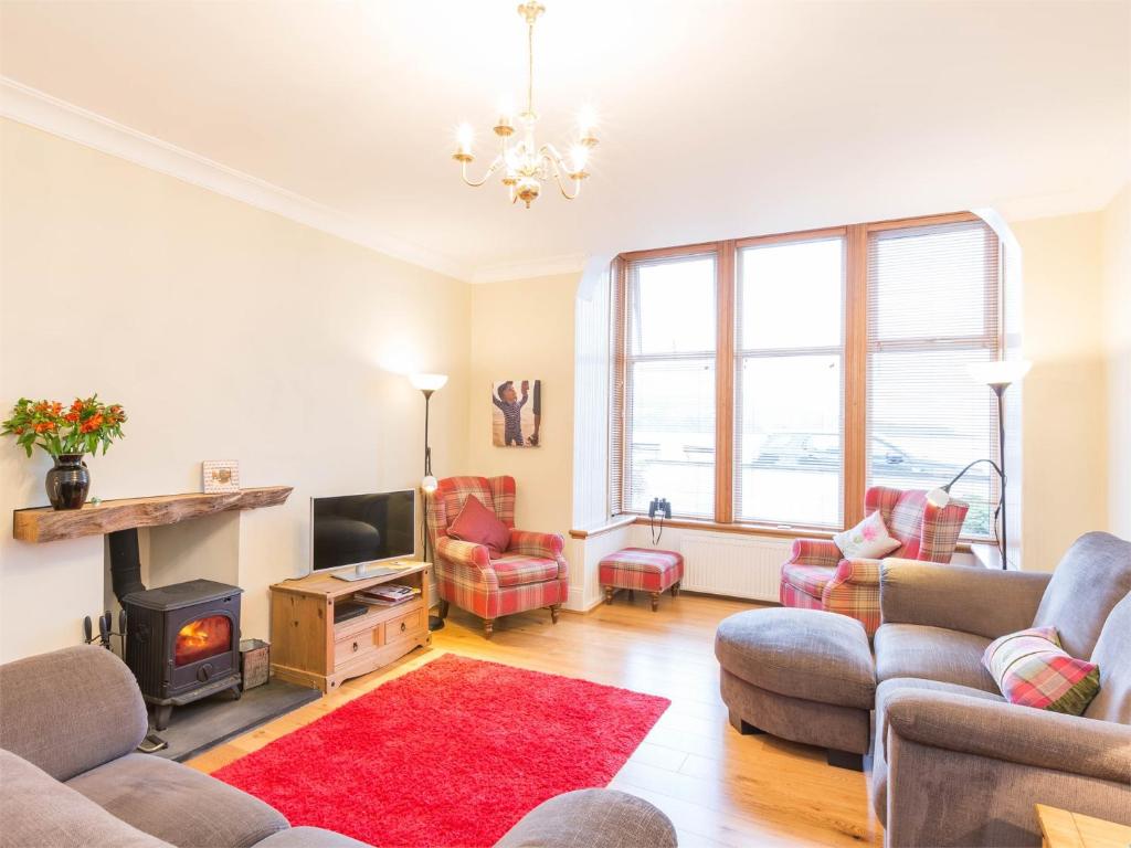 a living room with a couch and a fire place at 4 Bed in Brodick CA381 in Brodick