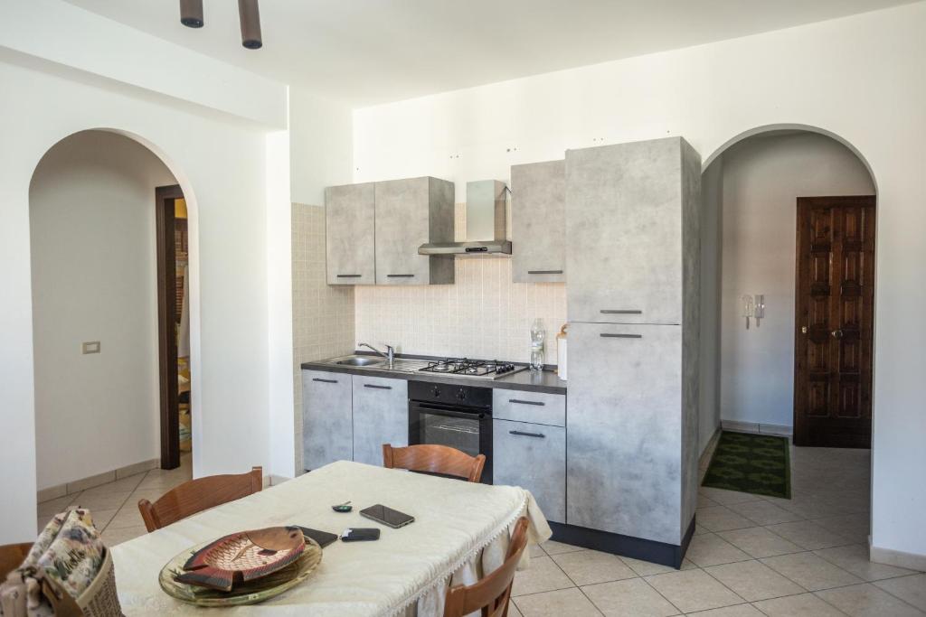 a kitchen with a table and a stove top oven at Il Sole di Scalea in Scalea