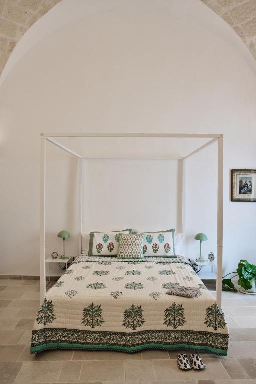 a bedroom with a large bed with a canopy at Silentio Suite N2-Ostuni-Jacuzzi in Ostuni