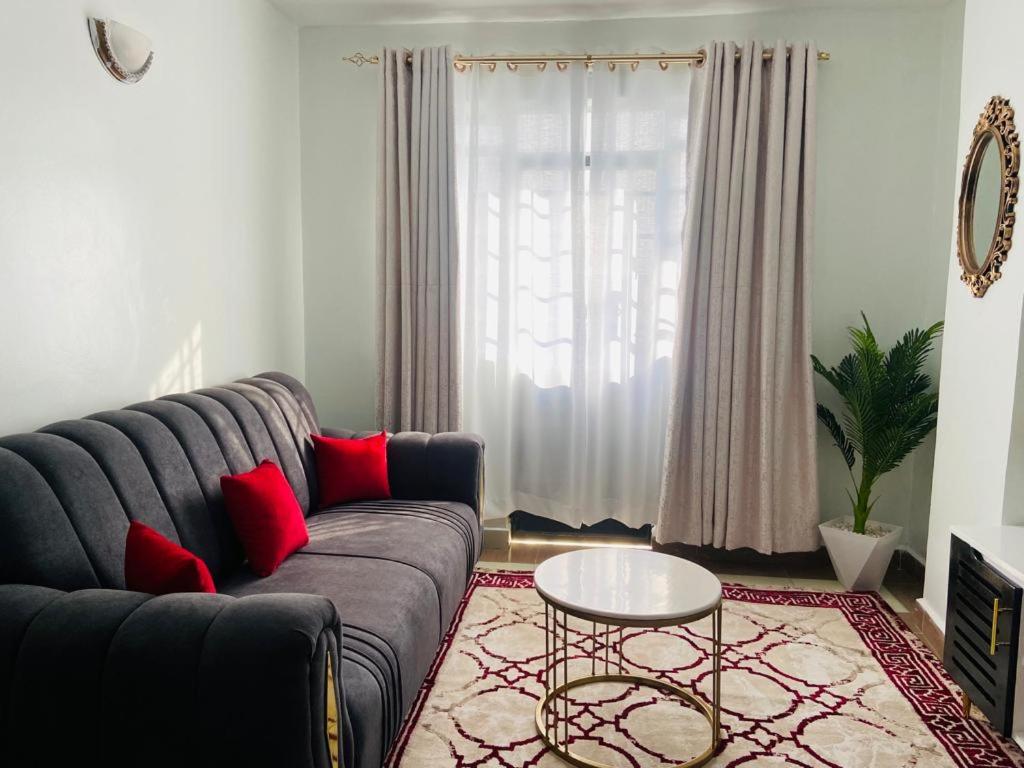 a living room with a couch and a table at Garden estate Thika road furnished home in Nairobi
