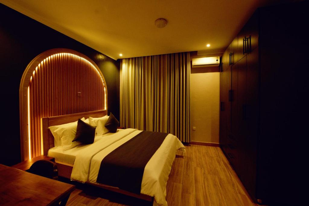 a hotel room with a bed and a table at 8TWENTY8 Residence in Kigali