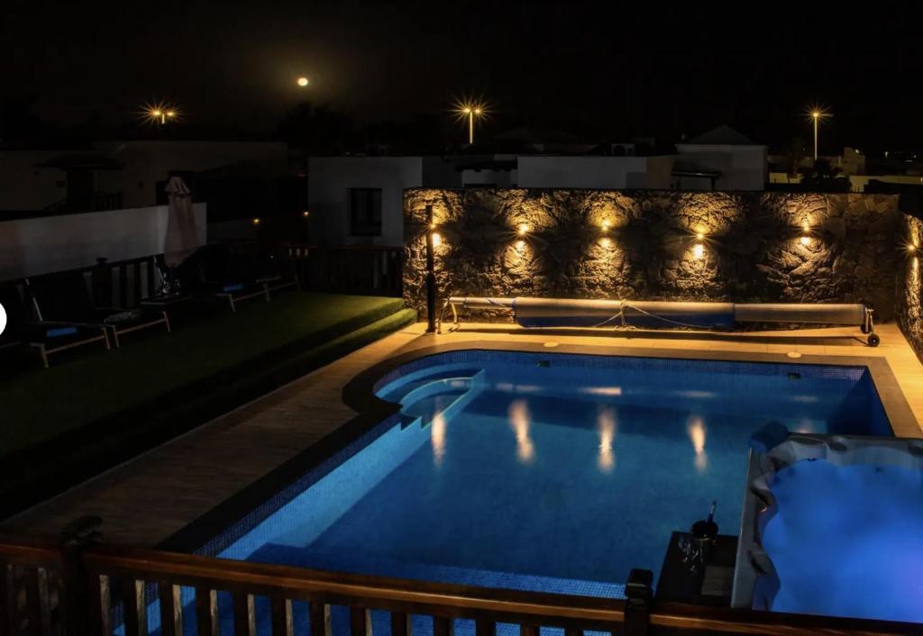 a swimming pool at night on a roof at Villa Casa Blanca in Playa Blanca