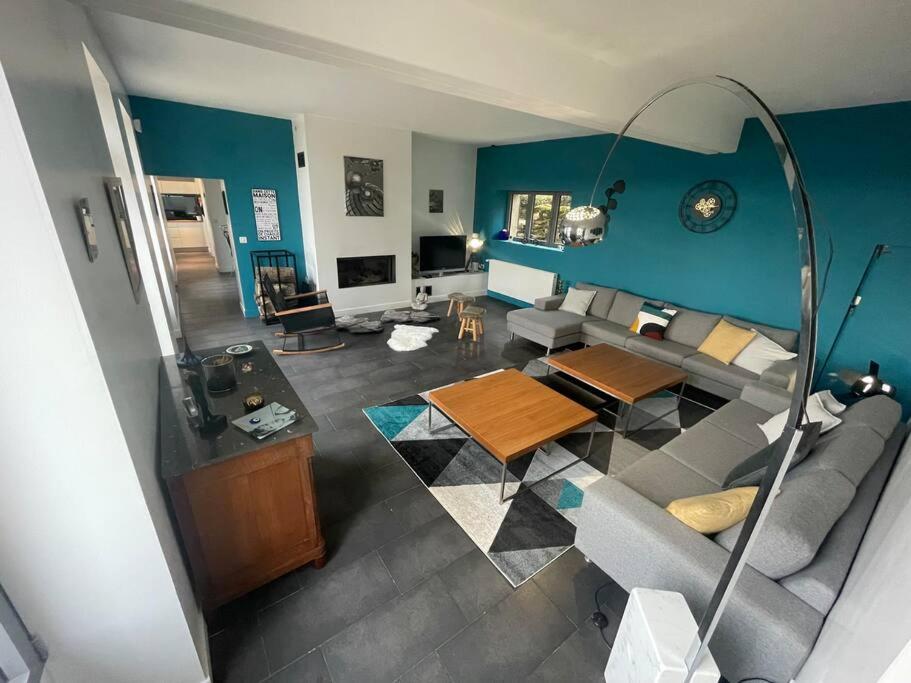 an overhead view of a living room with blue walls at Maison vue panoramique in Saint-Pierre-Aigle