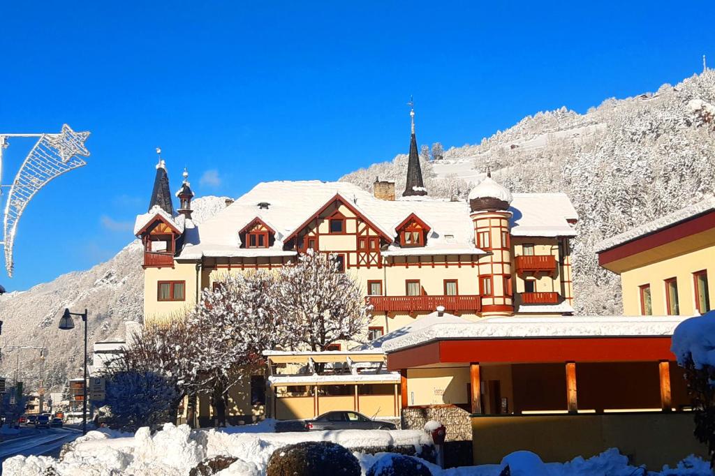 a large building with snow on it in front of a mountain at Hotel 3 Mohren in Oetz