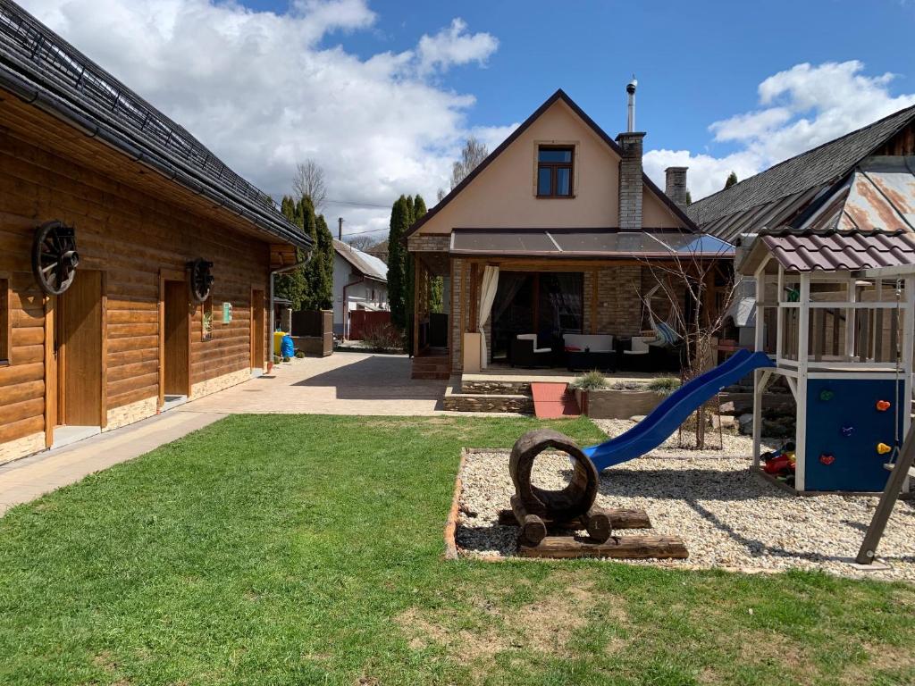 a playground in a yard next to a house at Chalupa Štúrka in Polomka