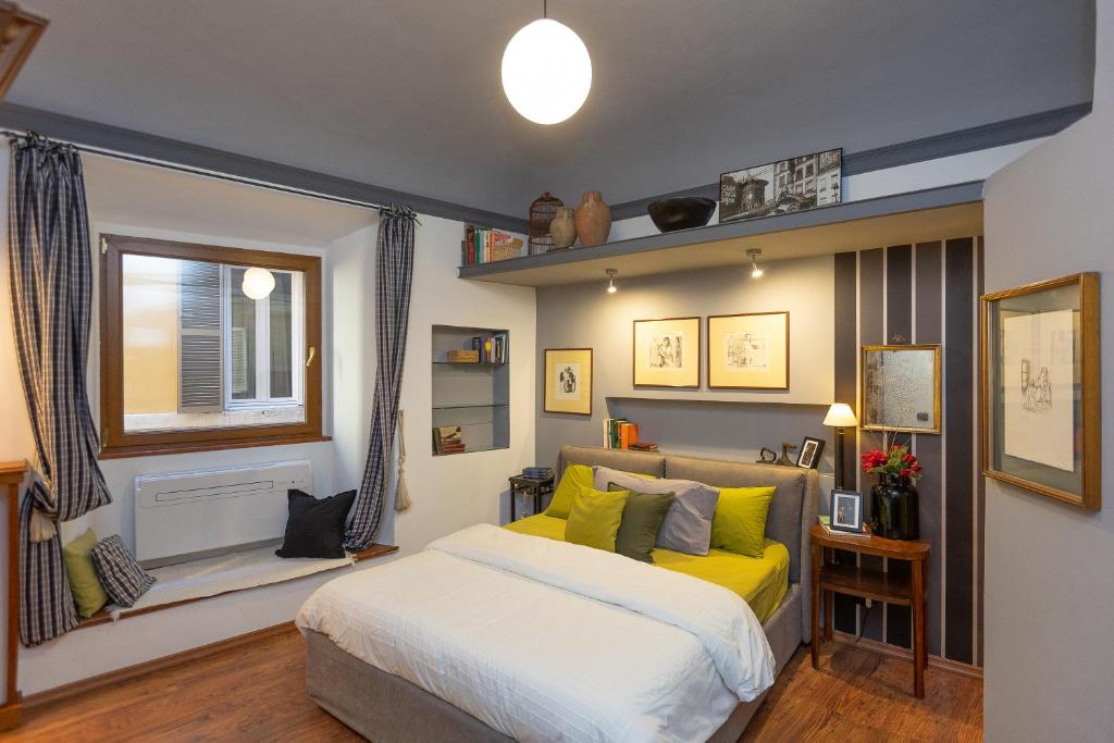 a bedroom with a yellow bed and a window at Pantheon by Rental in Rome in Rome