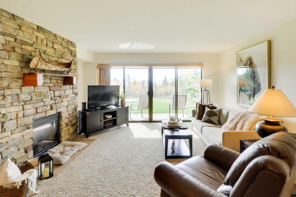 a living room with a couch and a fireplace at Beautiful Bigfork Condo with Hot Tub Access! in Bigfork