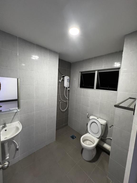 a bathroom with a toilet and a sink at Football Heritage in Sitiawan