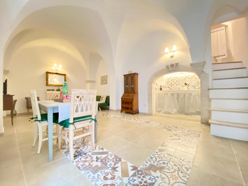 a large living room with a table and chairs at A&A B&B Martina Franca in Martina Franca