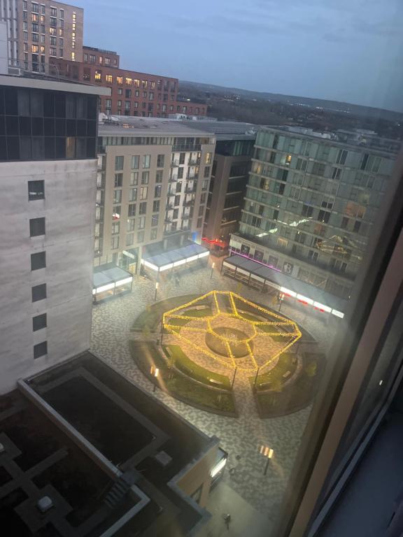 a view from a window of a building with a clock at Immaculate 1-Bed Apartment in Milton Keynes in Milton Keynes