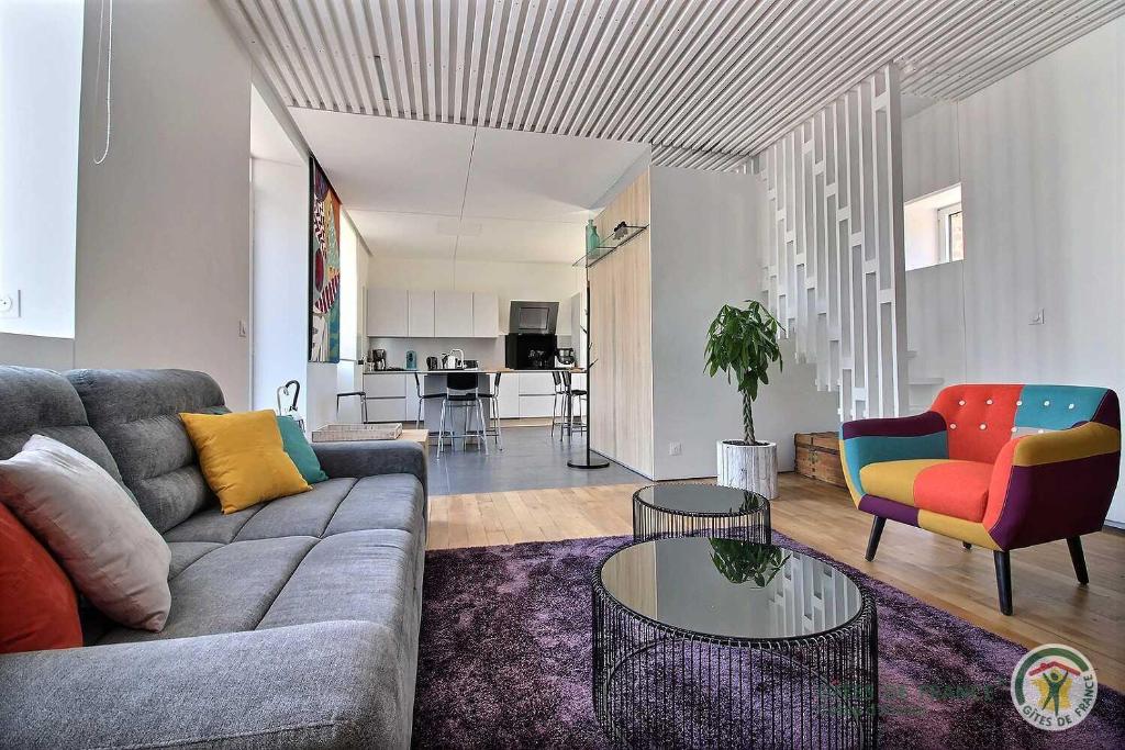 a living room with a couch and a table at La maison de lannion in Lannion