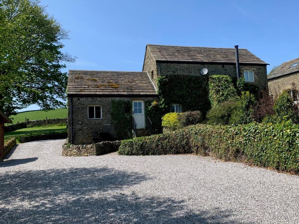 a house with a gravel driveway in front of it at 2 bed in Chapel-en-le-Frith PK346 in Chapel en le Frith