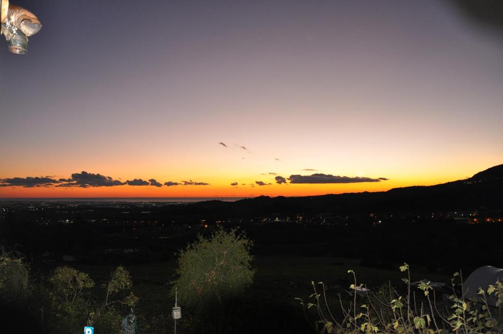 a sunset from the top of a hill at La Vecchia Lanterna in Montecorvino Rovella