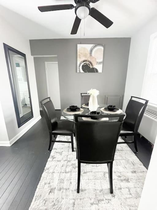 a dining room with a table with chairs and a ceiling fan at The Gateway: Entire Apartment 7 mins from airport in Cleveland