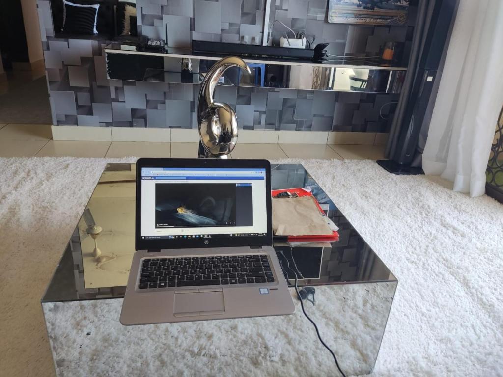 a laptop computer sitting on a glass table at 2BR Shanzu Serena in Mombasa