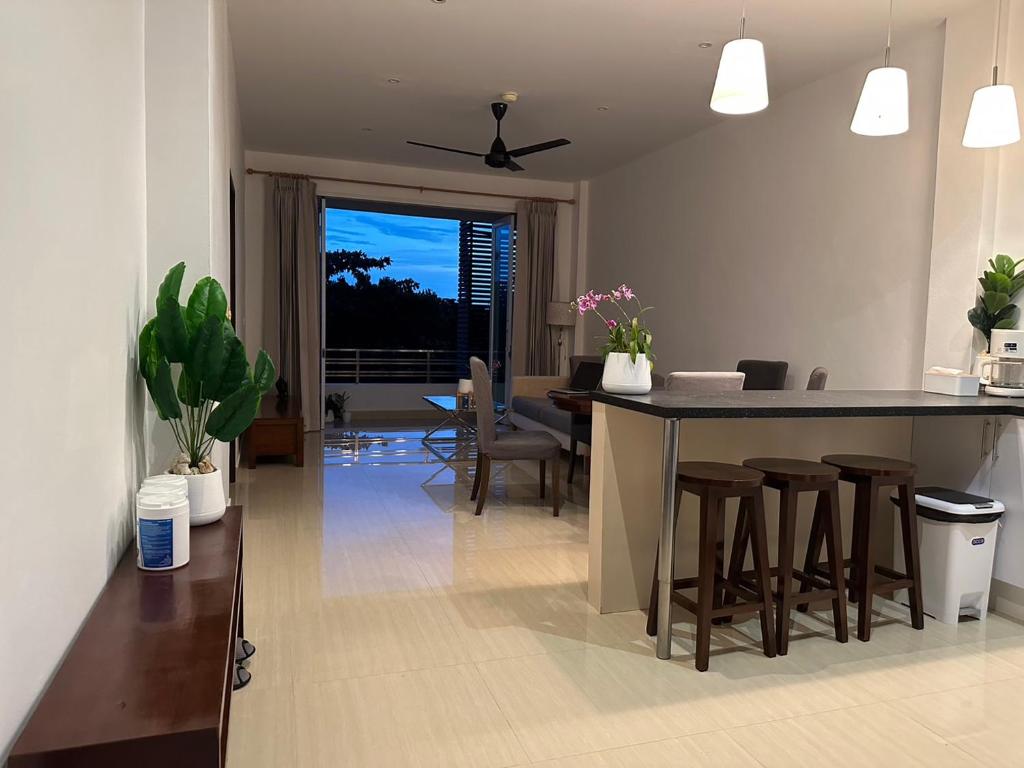 a kitchen and living room with a table and chairs at 2 Bedroom Seaview Lanta Sport Resort 303 in Phra Ae beach