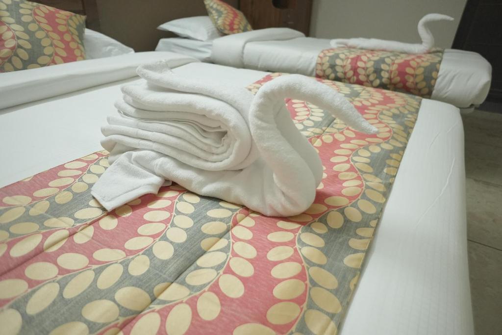 Postel nebo postele na pokoji v ubytování Luxe Hotel - Rooms & Villas Wayanad