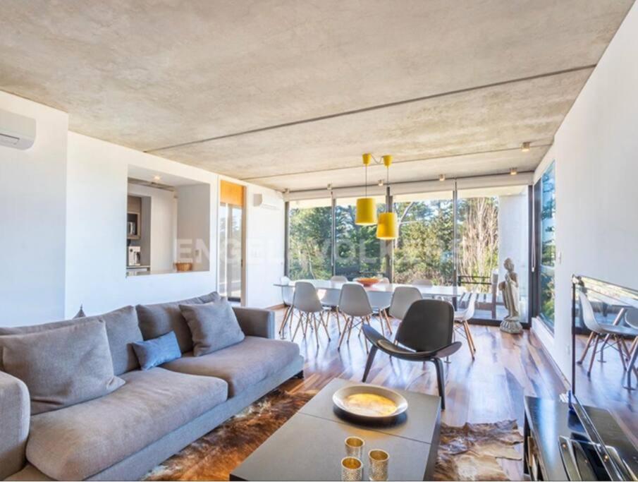 uma sala de estar com um sofá e uma mesa em Luminoso Penthouse en BeHouse em Punta del Este