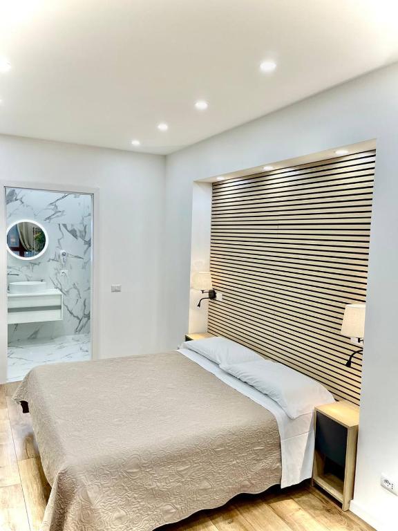 a bedroom with a large bed and a mirror at Perugia Family Flat in Perugia