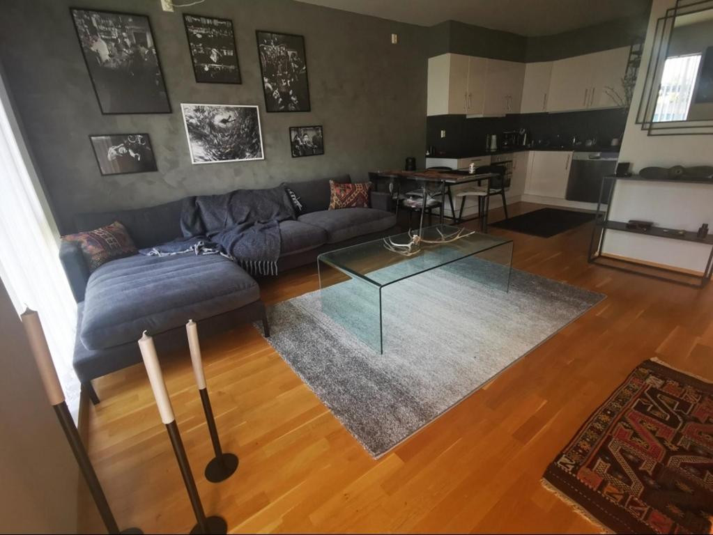 a living room with a couch and a glass table at Haugesund centrum apartment in Haugesund