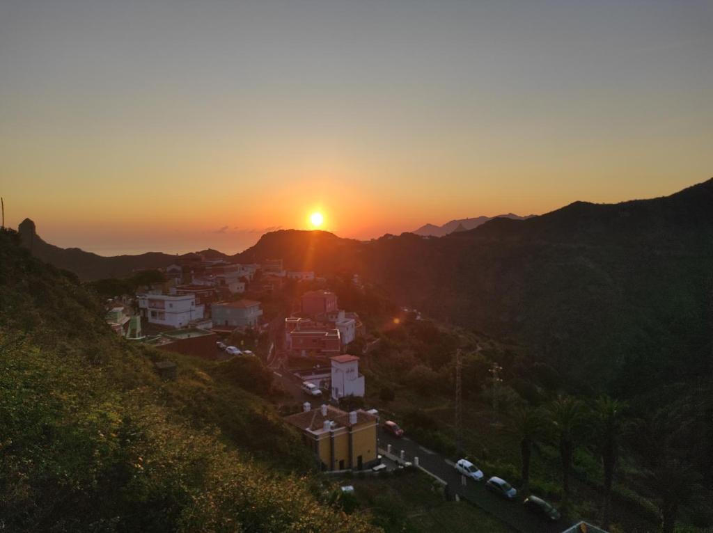 a view of a city at sunset from a hill at Casa las montañas de Anaga in Las Lagunas