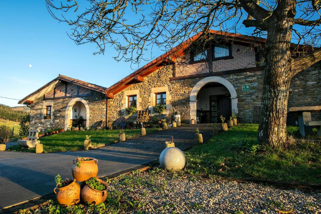 a stone house with pumpkins in front of it at ZELAI in Mallavia