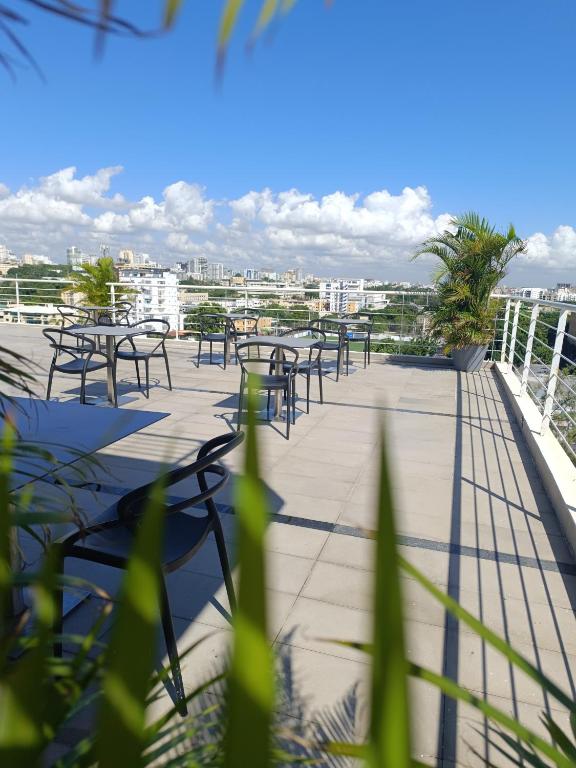 a row of tables and chairs on a balcony at LINCOLN SUITE in Santo Domingo