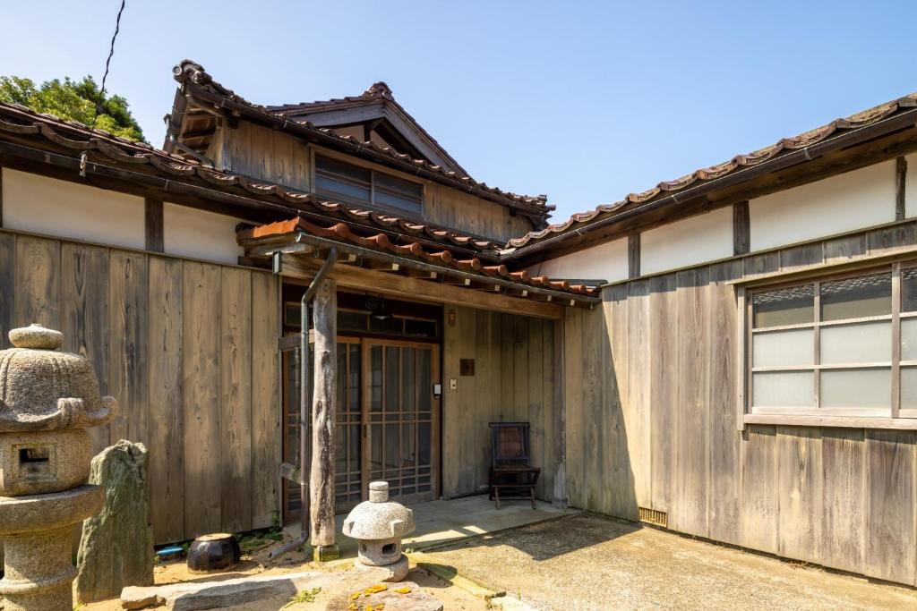 an asian house with a wooden fence at MAGONI - Vacation STAY 66671v in Kaga