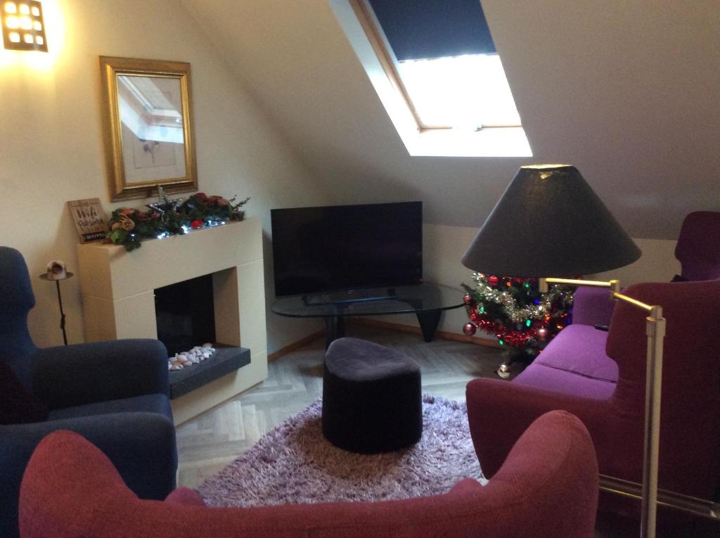 a living room with a christmas tree and a fireplace at 2 Bedroom Furnished Apartment in a Rural Position in Stone