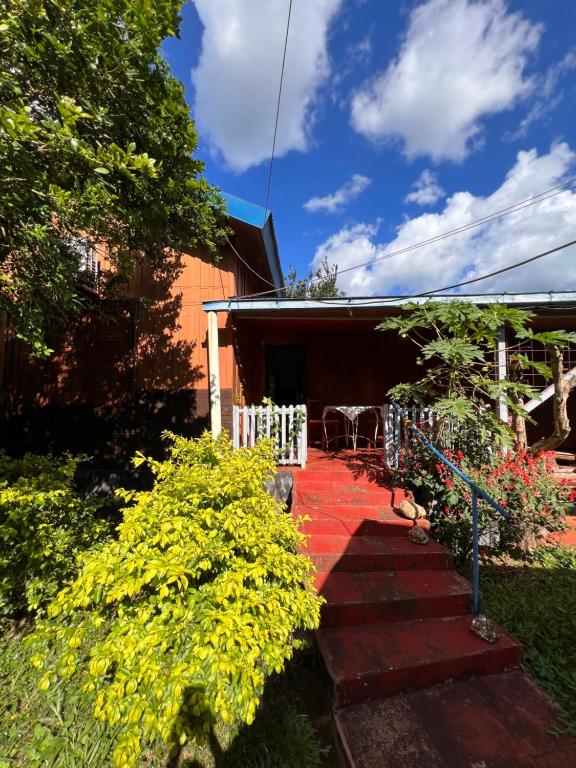 a set of stairs leading to a house with flowers at Dorbozy in Wanda