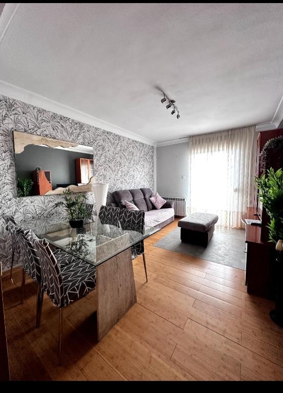 a living room with a table and a couch at Vista a la montaña Briviesca in Briviesca