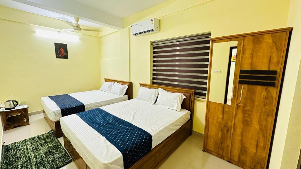 Postel nebo postele na pokoji v ubytování Mystique Inn Wayanad